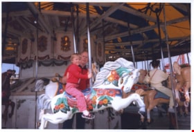 Elizabeth Knudson riding on Parker no. 119 carousel, August 28, 1985 thumbnail