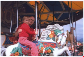 Elizabeth Knudson riding on C.W. Parker no. 119 carousel, August 28, 1985 thumbnail