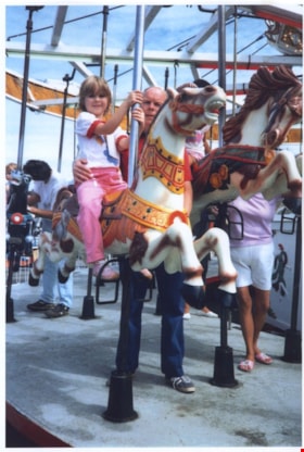 Elizabeth Knudson riding on C.W. Parker no. 119 carousel, August 23, 1986 thumbnail