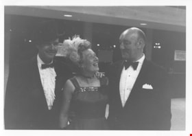 Woman with two men at Centennial Ball, 15 May 1971 thumbnail