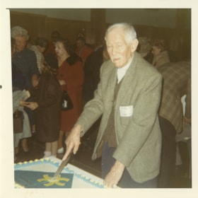 Man cutting cake at Burnaby Pioneer celebration, 9 May 1971 thumbnail