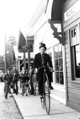Costumed man on bicycle in Heritage Village, November 1971 thumbnail