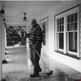 Sandy Stewart sweeping porch of Elworth House, Heritage Village, [1971] thumbnail
