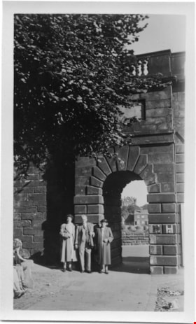 Three people posing near stone archway, [1952] thumbnail