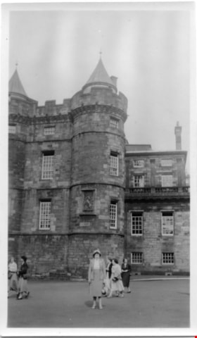 Woman posing in front of a stone castle, [1952] thumbnail