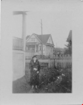Woman in side yard of a house, [between 1930 and 1950] thumbnail
