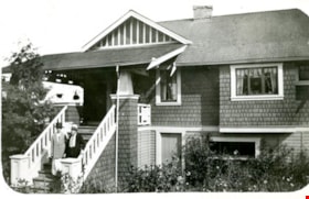 Mr and Mrs Martin standing on front steps of 4108 Trinity Street, [192--] thumbnail