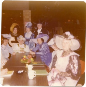 Confederation Singers in costumes sitting at a table., 1970-1980 thumbnail