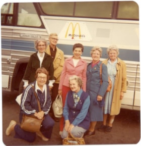 Six women and a man standing in front of a bus., 1970-1980 thumbnail