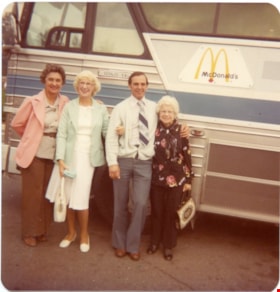 Three women and a man in front of a bus., 1970-1980 thumbnail