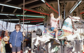 Russell children riding carousel at PNE, June 1967 thumbnail