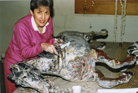 Faye Diamond stripping paint from carousel horse, [between 1990 and 1992] thumbnail