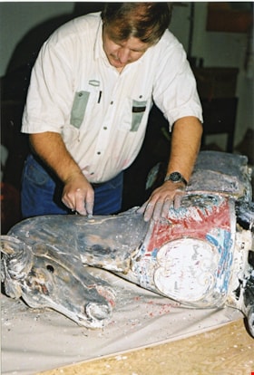 Volunteer stripping paint from carousel horse, [between 1990 and 1992] thumbnail