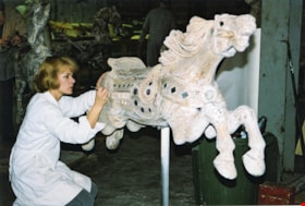 Volunteer working on carousel horse named  thumbnail