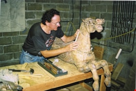 Bill Henderson working on carousel horse named The Colonel, [between 1990 and 1992] thumbnail