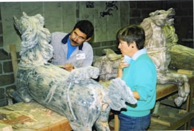 Volunteers working on carousel horse named Mr. Ed, [between 1990 and 1992] thumbnail
