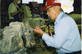 Ed Stebner making a repair to a carousel horse, [between 1990 and 1992] thumbnail