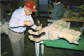 Ed Stebner making repairs to carousel horse named Betty B, [between 1990 and 1992] thumbnail