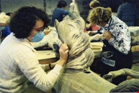 Carma Ferreira stripping paint from a carousel horse, [between 1990 and 1992] thumbnail
