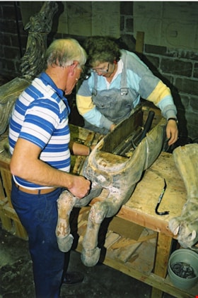 Bob Watts and Marie McIlhiney at work repairing a carousel horse, [between 1990 and 1992] thumbnail