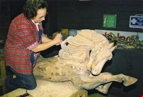 Dorothy Clarke working on carousel horse named Vivian, [between 1990 and 1992] thumbnail