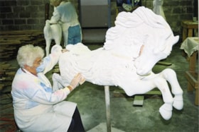Restoration volunteer sanding a carousel horse named Scampering Dawn, [between 1990 and 1992] thumbnail
