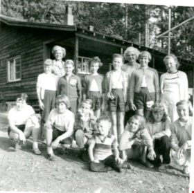 Group of people outside a log cabin, Sep 1958 thumbnail