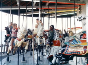 Young riders on C.W. Parker Carousel at the PNE, [1960-1969] thumbnail