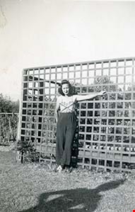 Suey Ying Jung (Laura) standing in garden, [between 1946 and 1955] thumbnail