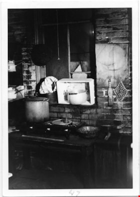 Way Sang Yuen Wat Kee & Co. kitchen with stove and white shelf, 1975 thumbnail