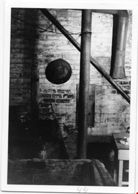 Way Sang Yuen Wat Kee & Co. kitchen with four metal pipes against brick wall, 1975 thumbnail
