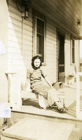 Suey Ying Jung (Laura) sitting on porch, [between 1942 and 1955] thumbnail