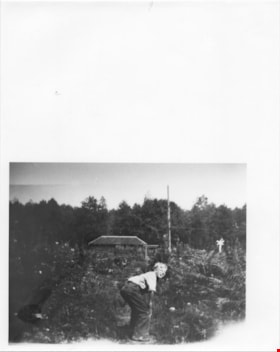 Boy crouched in a field, thumbnail