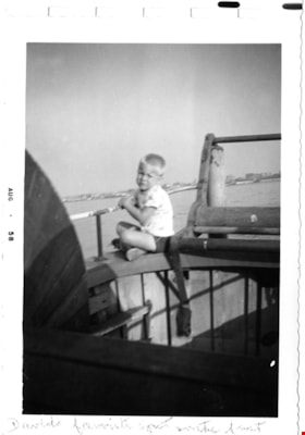David Sanders sitting on the side of a boat, Aug. 1958 thumbnail