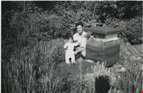 John and Janice Wuzinski with a bee hive., 1949 thumbnail