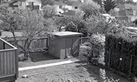 Outbuilding in next yard, southwest view from kitchen roof, May 6, 1988 thumbnail
