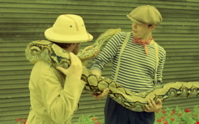 Two men with snake, July 11, 1990 thumbnail