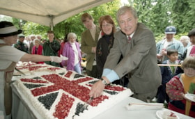 Burnaby Mayor Doug Drummond cutting Union Jack cake at Canada Day event, July 1997 thumbnail