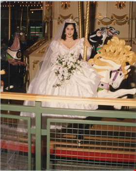 Bride riding C.W. Parker Carousel, [1993] thumbnail
