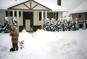 Wally Westerman shovelling snow in front of his house, [198-] thumbnail