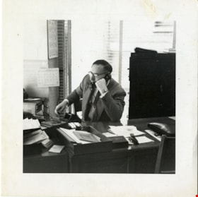Joe Corsbie working at Gulf and Fraser Fishermen's Credit Union, 1954 thumbnail