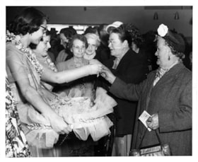 Handing out orchids on opening day, 5 May 1954 thumbnail