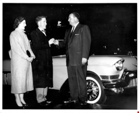 T. Boyd Haskell handing car keys to contest winners, Nov. 1957 thumbnail