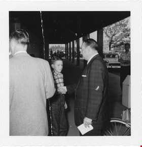 T. Boyd Haskell shaking hands with child, [1958] thumbnail