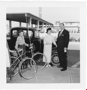 Haskell with woman and children outside of Simpsons-Sears, [1958] thumbnail