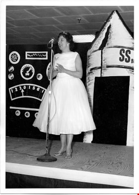 Woman speaking into microphone, [1959] thumbnail