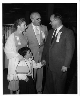 Al Moore with Simpsons-Sears manager and family, 5 May 1954 thumbnail