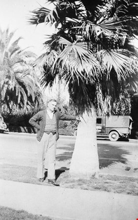 Jimmy Robertson leaning against a palm tree, [1936] (date of original), copied 1996 thumbnail
