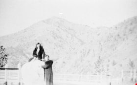 Two women posing with large boulder in the Siskiyou Mountains, [1936] (date of original), copied 1996 thumbnail