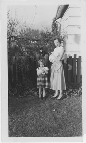 Adell Philips and daughter holding rabbits, [1956] thumbnail
